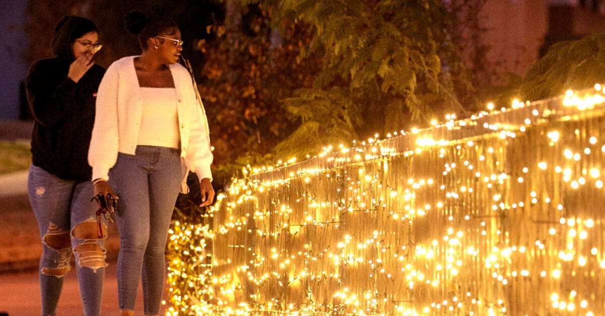 UA Little Rock students enjoy the beautiful holiday lights on campus. Photo by Ben Krain.