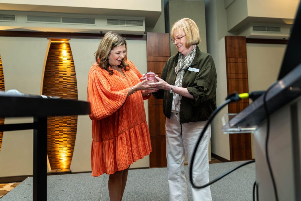 UA Little Rock's Carrie Phillips receives the CASE Crystal Apple from CASE's Terry Flannery.