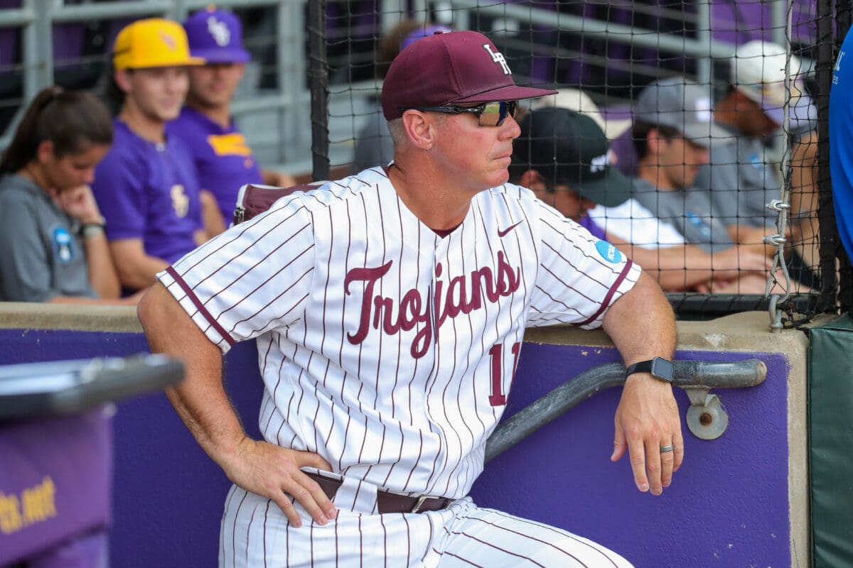 UA Little Rock baseball coach Chris Curry stands on the top step of the dugout at Alex Box Stadium during the Trojans' NCAA Regional tournament game against LSU