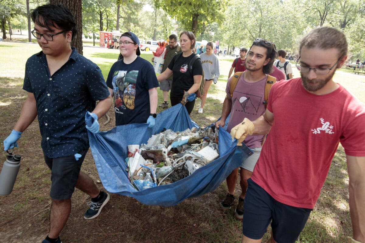 UA Little Rock students clean up Coleman Creek by removing trash.