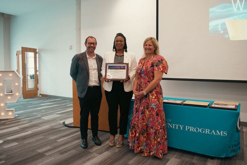 Aaron Duvall (left), UA Little Rock's executive director of Workforce Development, and Emily Cox (right), the university's vice chancellor for University Affairs, receive the Partner of the Year award from the city of Little Rock Department of Community Programs and Monica Montgomery (center), Community Programs Career Workforce Development coordinator for the city.