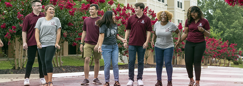 Happy students walking on campus after receiving University of Arkansas scholarships