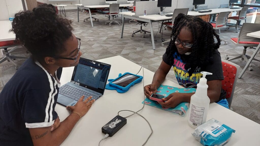 UWC Staff Member helping a client with their writing.